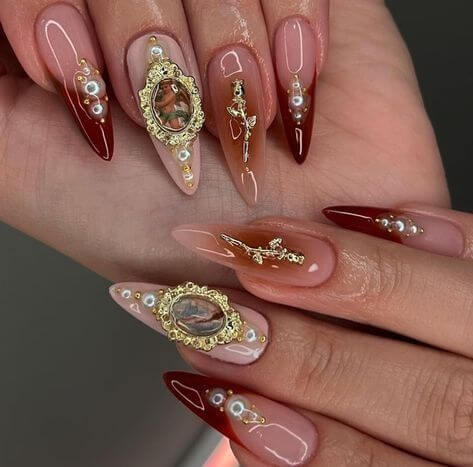 gold embellishments on nails for mob wife aesthetic
